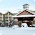 Modern hotel exterior with snow-covered architecture, showcasing The Husna Experience for 2025 desktop mega menu.
