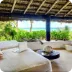 Relaxing outdoor lounge with comfortable seating, lush greenery, and scenic views, perfect for unwinding and enjoying nature at The Husna Experience.